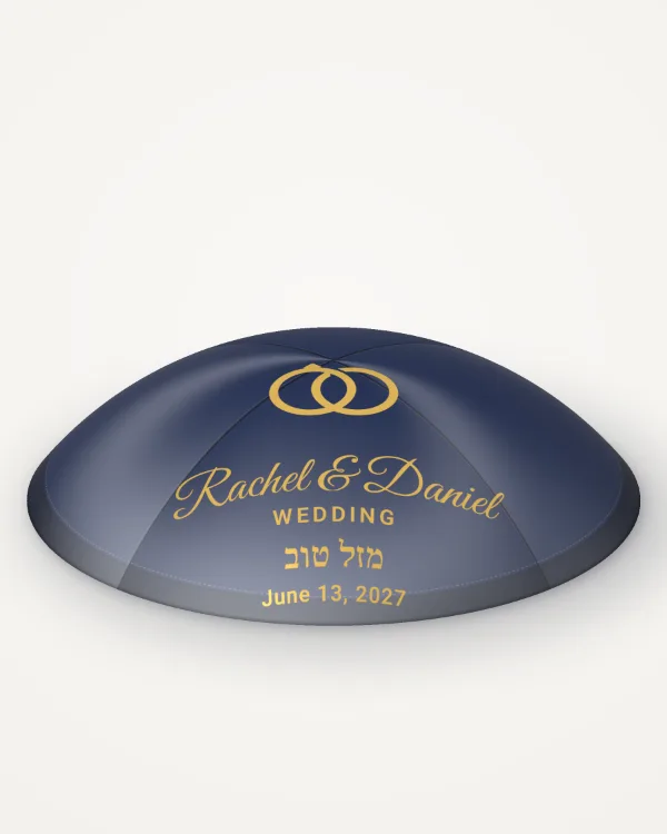 Navy satin kippah, golden rings design in gold foil with the sample text “Rachel & Daniel”, rendered picture