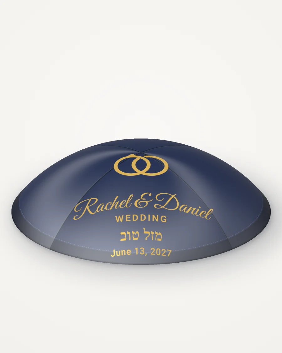 Navy satin kippah with gold rings and the sample names Rachel and Daniel. Rendered picture; it changes as you type.