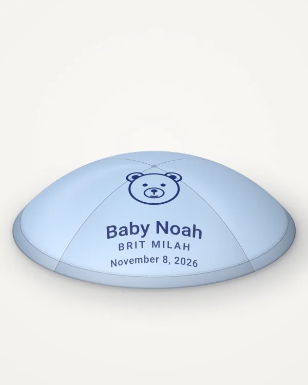 Sky blue satin kippah, little bear design in navy ink with the sample text “Baby Noah”, rendered picture