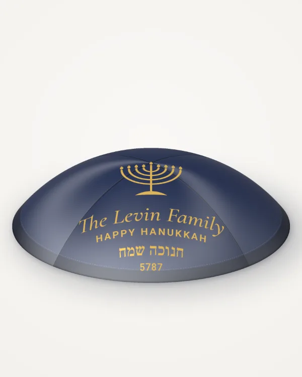 Navy satin kippah, hanukkah menorah design in gold foil with the sample text “The Levin Family”, rendered picture