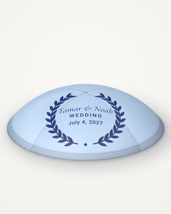Sky blue satin kippah, olive wreath design in navy ink with the sample text “Tamar & Noah”, rendered picture