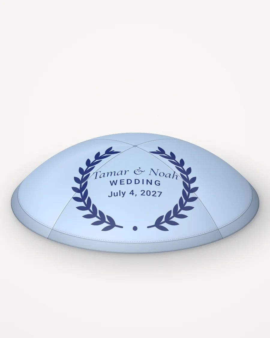 Sky blue satin kippah, olive wreath design in navy ink with the sample text “Tamar & Noah”, rendered picture