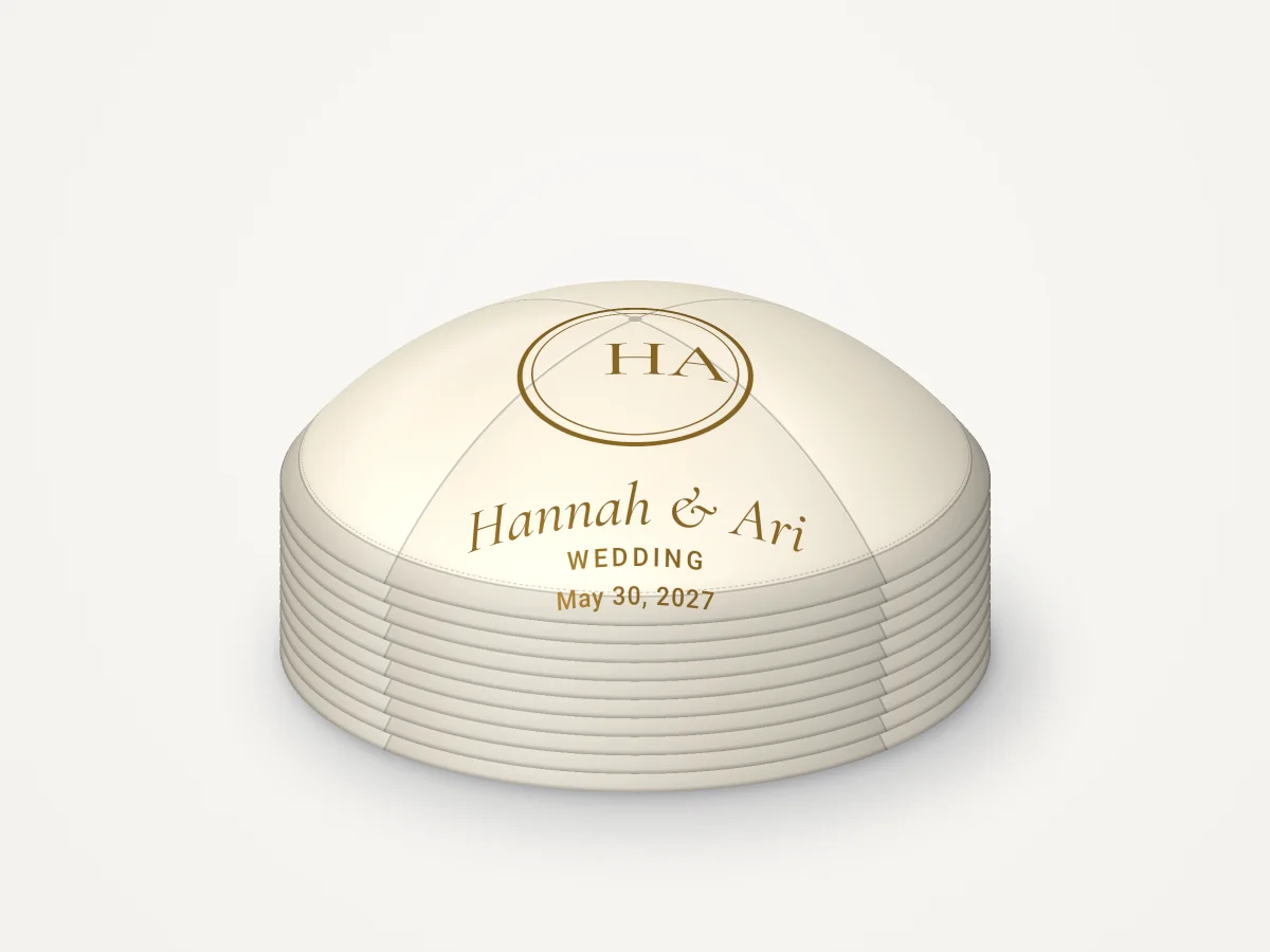 A stack of ten ivory kippahs with gold print