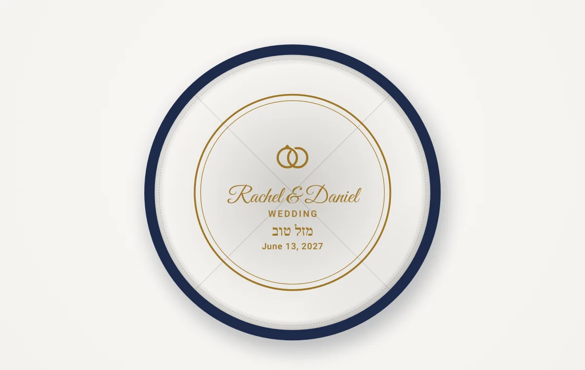 The white lining of a kippah seen from below, with a gold stamp: rings, the names Rachel and Daniel and the date